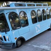 a turquoise trolley on the street